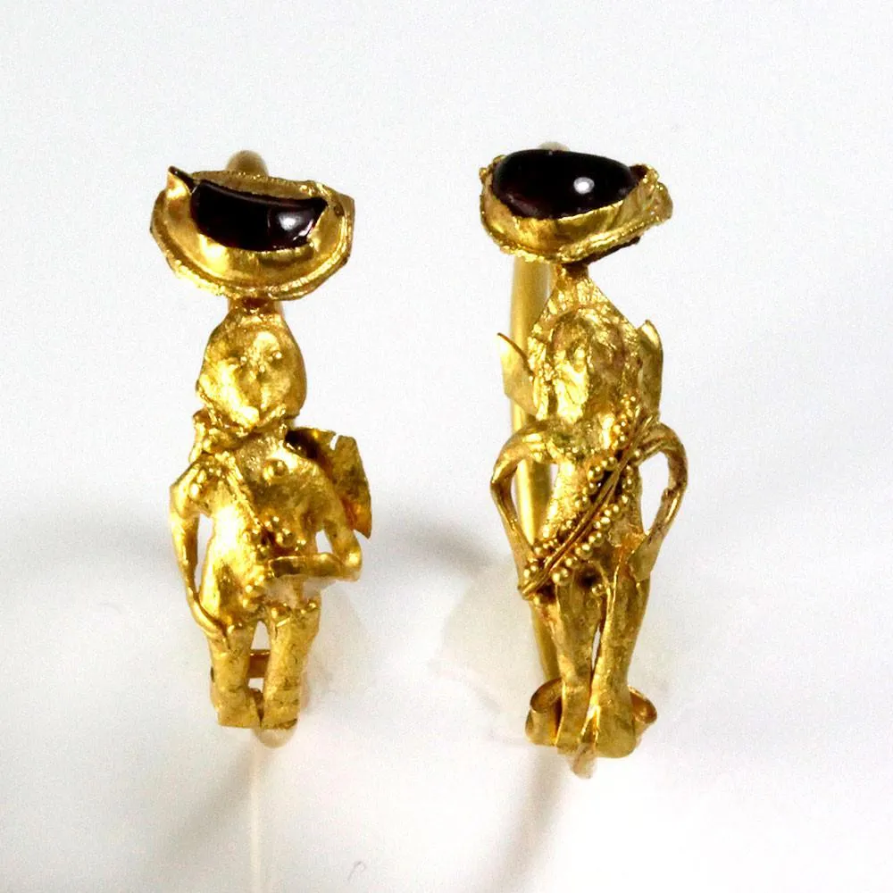 A Pair of Gold & Garnet Earrings of Eros, Hellenistic Period, ca. 2nd - 1st century BCE