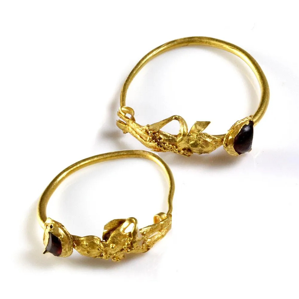 A Pair of Gold & Garnet Earrings of Eros, Hellenistic Period, ca. 2nd - 1st century BCE